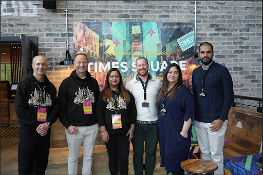 Six team members standing together at an event.